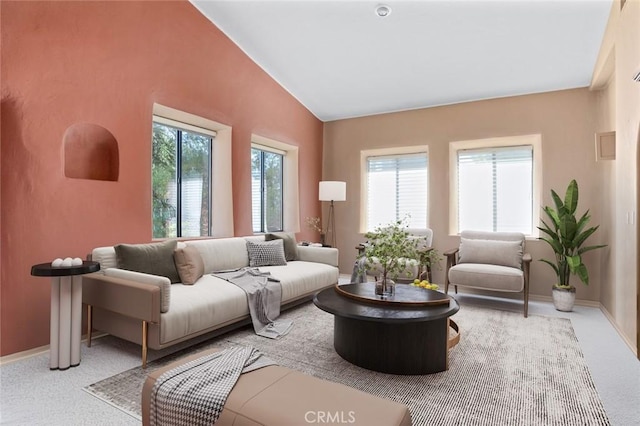 living room featuring vaulted ceiling and light colored carpet