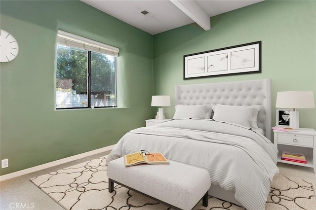 carpeted bedroom featuring beam ceiling