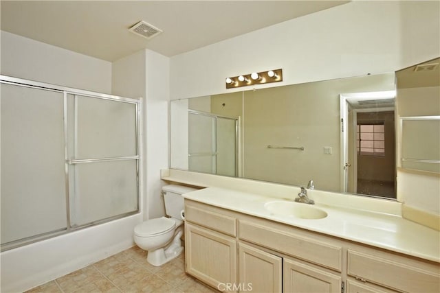 full bathroom with vanity, toilet, and combined bath / shower with glass door