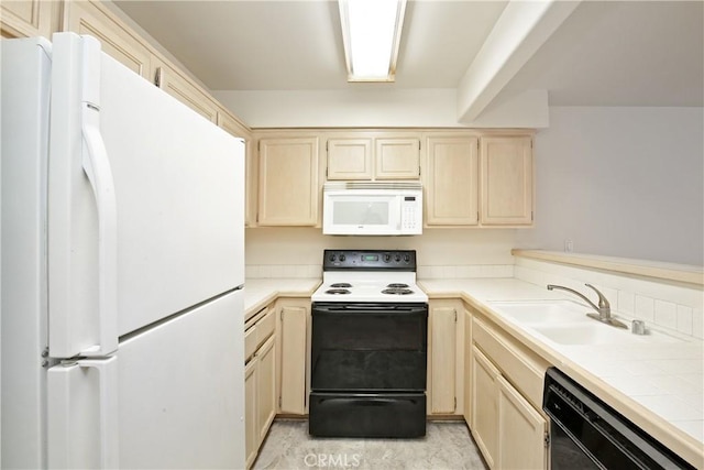 kitchen featuring sink, tile counters, and white appliances