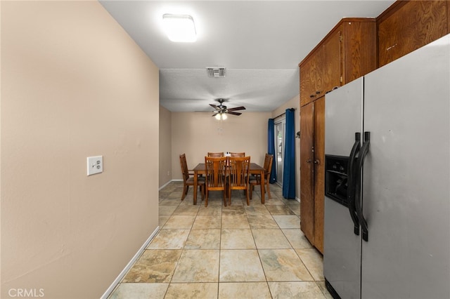 tiled dining room with ceiling fan