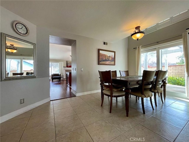 dining space with light tile patterned floors and a wealth of natural light