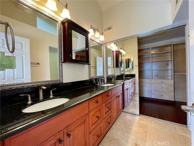 bathroom with vanity and vaulted ceiling