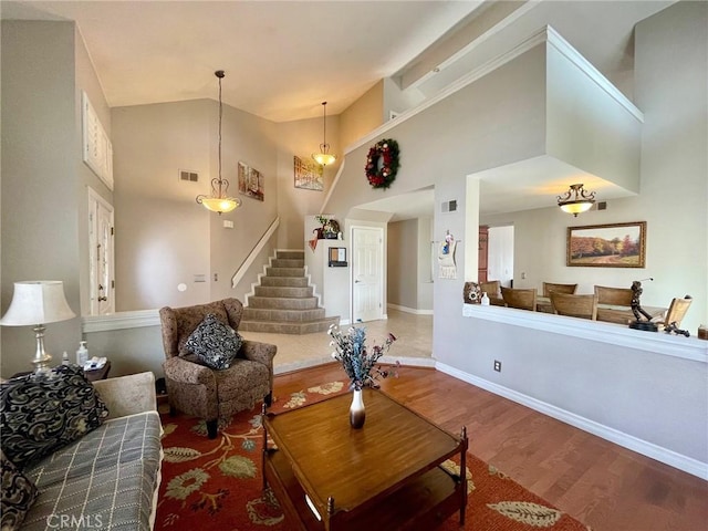 living room with hardwood / wood-style flooring and high vaulted ceiling