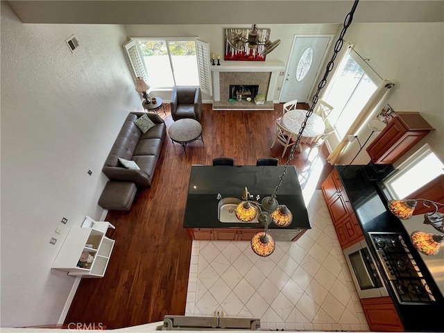 living room with hardwood / wood-style floors and a tile fireplace