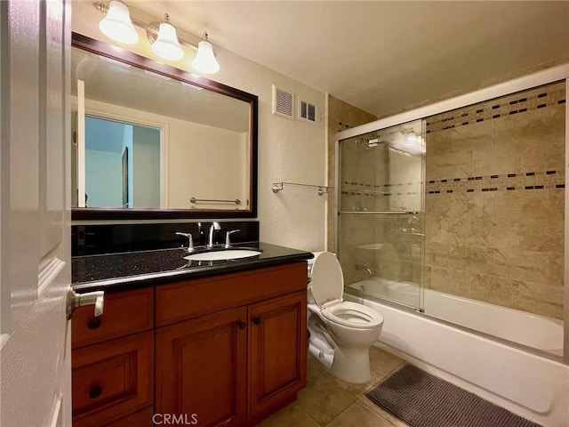 full bathroom featuring vanity, tile patterned flooring, enclosed tub / shower combo, and toilet