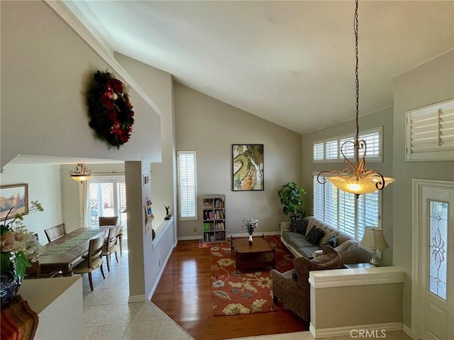 living room featuring light tile patterned flooring and high vaulted ceiling