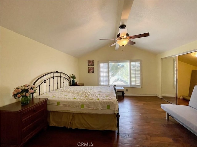 bedroom with ceiling fan, dark hardwood / wood-style floors, vaulted ceiling, and a closet