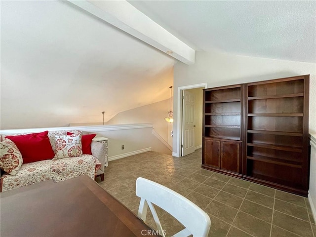 living room with lofted ceiling with beams and dark tile patterned flooring