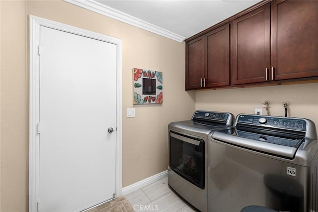 laundry room featuring cabinets, separate washer and dryer, and ornamental molding