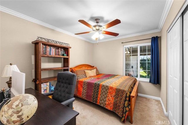 carpeted bedroom with a closet, ceiling fan, and ornamental molding