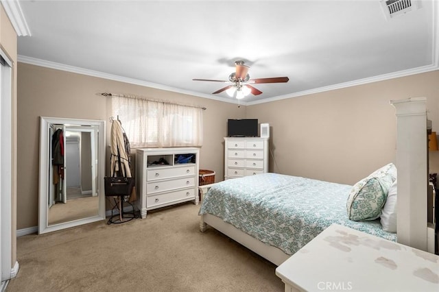 bedroom with ceiling fan, ornamental molding, and carpet flooring