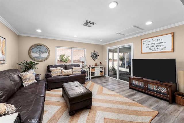 living room with light wood-type flooring and ornamental molding