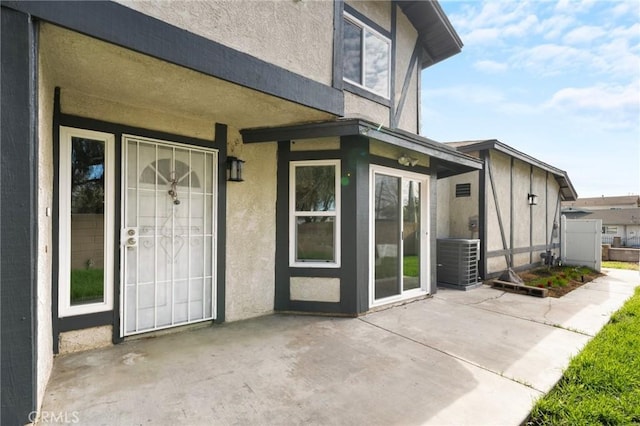 doorway to property featuring a patio and cooling unit