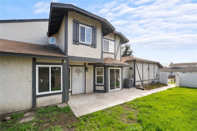 back of house featuring a patio and a lawn