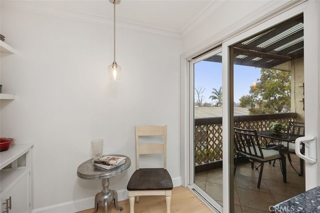 interior space with ornamental molding, baseboards, and wood finished floors