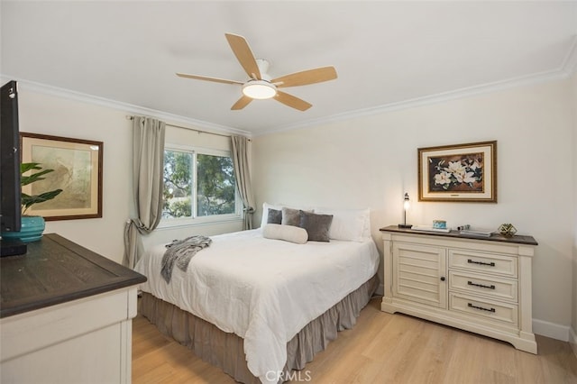 bedroom with light wood finished floors and crown molding