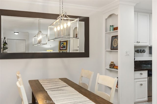 dining area with built in shelves and crown molding