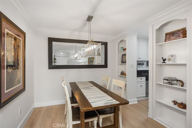 dining room featuring an inviting chandelier, light wood-style flooring, baseboards, and ornamental molding