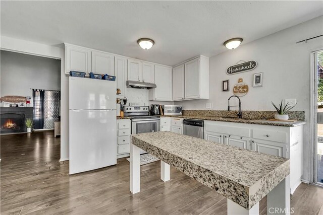 44536 Benald St, Lancaster, CA 93535 - kitchen with appliances with stainless steel finishes, white cabinets, and wood-type flooring
