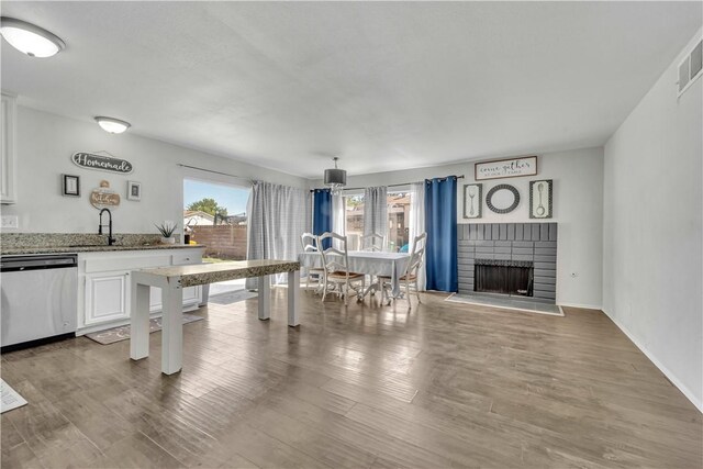 44536 Benald St, Lancaster, CA 93535 - kitchen featuring white cabinets, light stone countertops, hardwood / wood-style floors, and dishwasher