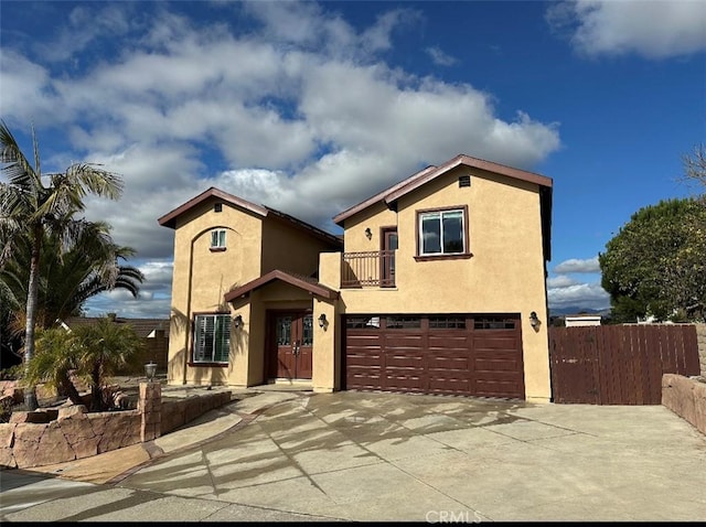 mediterranean / spanish house featuring a garage and a balcony