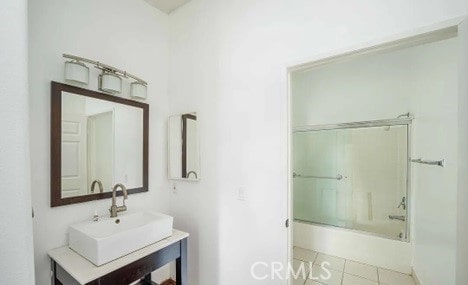 bathroom with tile patterned flooring, vanity, and shower / tub combination