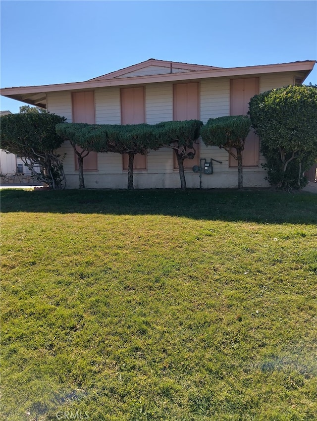 view of home's exterior with a lawn