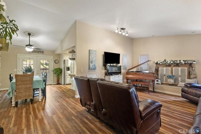 living room with ceiling fan, wood-type flooring, french doors, and lofted ceiling