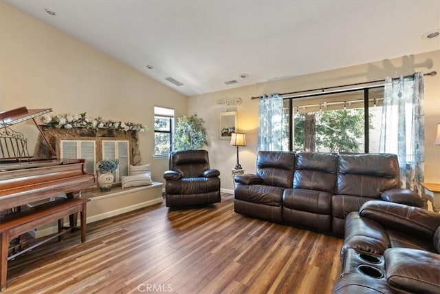 living room with vaulted ceiling and wood-type flooring