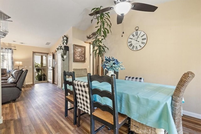 dining space featuring ceiling fan, vaulted ceiling, and wood-type flooring