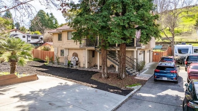 616 Jackson Dr, Paso Robles, CA 93446 - view of front of property with stucco siding, stairway, and concrete driveway