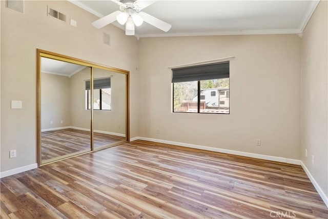 616 Jackson Dr, Paso Robles, CA 93446 - unfurnished bedroom with wood finished floors, crown molding, a closet, and ceiling fan