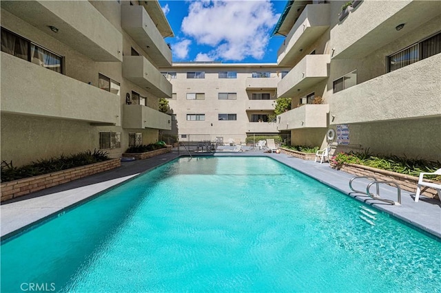 community pool with a patio area