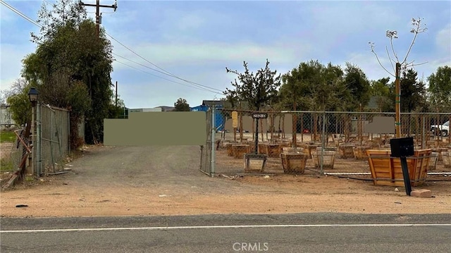 view of play area with fence and a gate