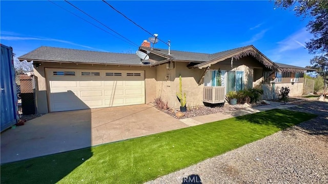 single story home with an attached garage, driveway, and stucco siding