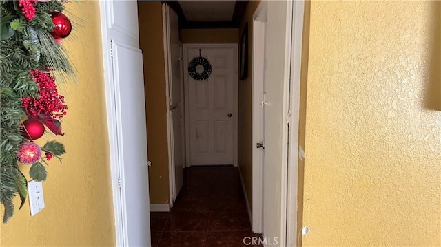 hall featuring dark tile patterned floors