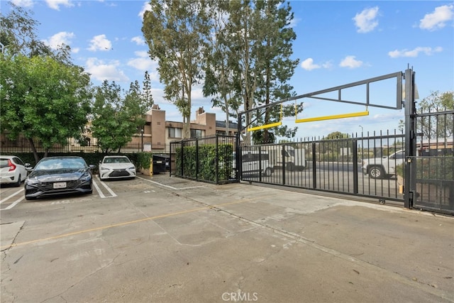 7826 Topanga Canyon Blvd Unit 101, Canoga Park, CA 91304 - uncovered parking lot featuring a gate and fence