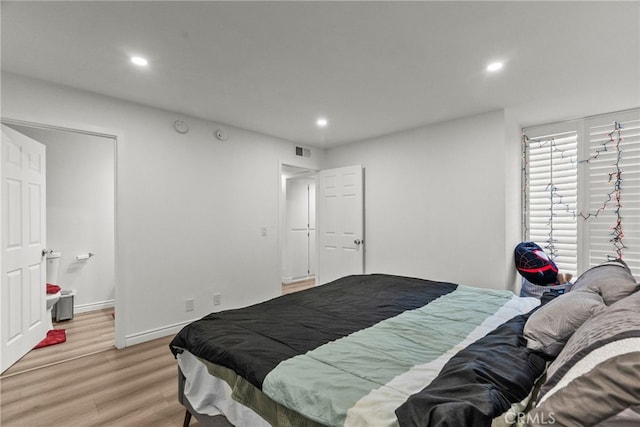 7826 Topanga Canyon Blvd Unit 101, Canoga Park, CA 91304 - bedroom featuring baseboards, recessed lighting, visible vents, and light wood-style floors