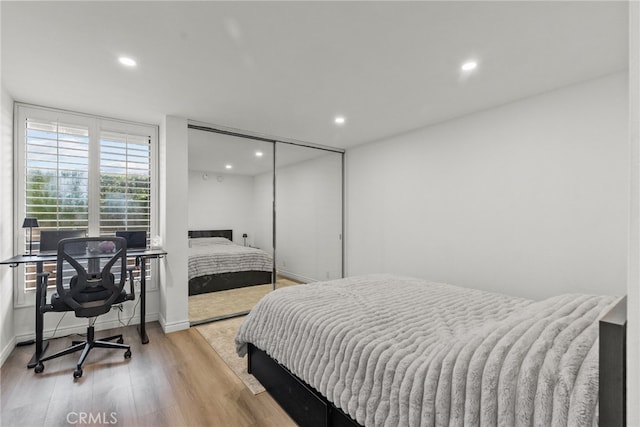 7826 Topanga Canyon Blvd Unit 101, Canoga Park, CA 91304 - bedroom with recessed lighting, a closet, baseboards, and wood finished floors