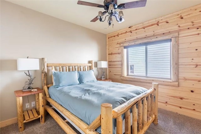 bedroom with wooden walls, carpet, and a ceiling fan