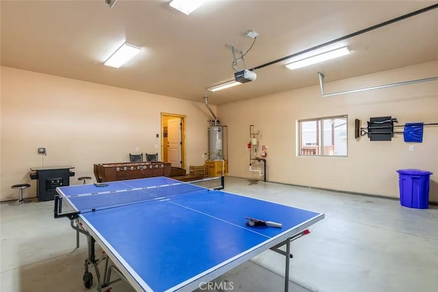 playroom with water heater, concrete flooring, and a garage
