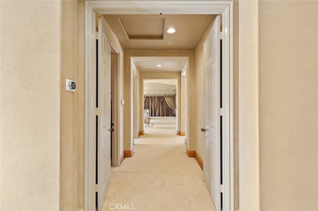 hallway featuring light carpet