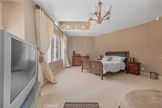 bedroom with a chandelier and light colored carpet