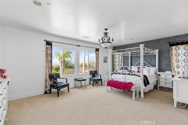 bedroom with a notable chandelier and light colored carpet