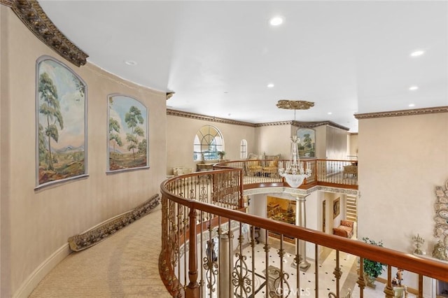 corridor featuring crown molding and light colored carpet