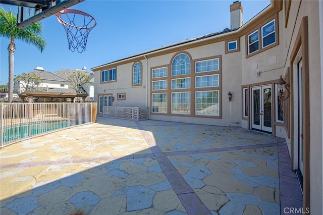 view of patio / terrace featuring a fenced in pool and french doors