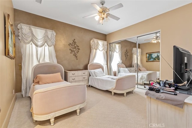 bedroom with carpet, a closet, and ceiling fan