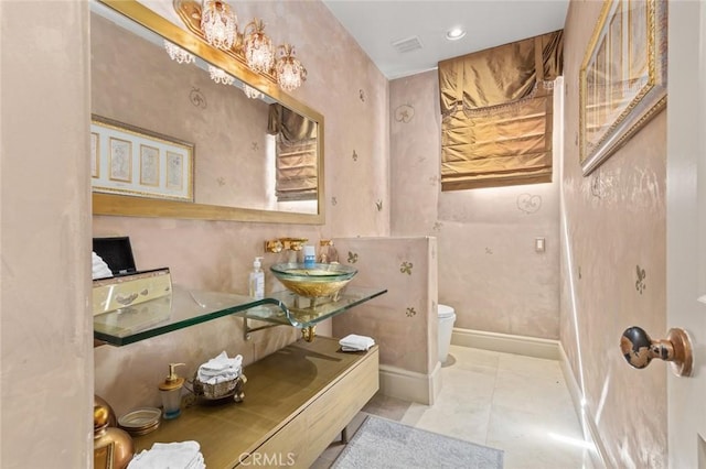 bathroom with sink, toilet, and tile patterned floors