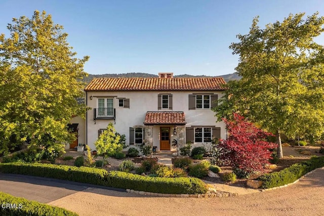 mediterranean / spanish-style home featuring a tile roof and stucco siding